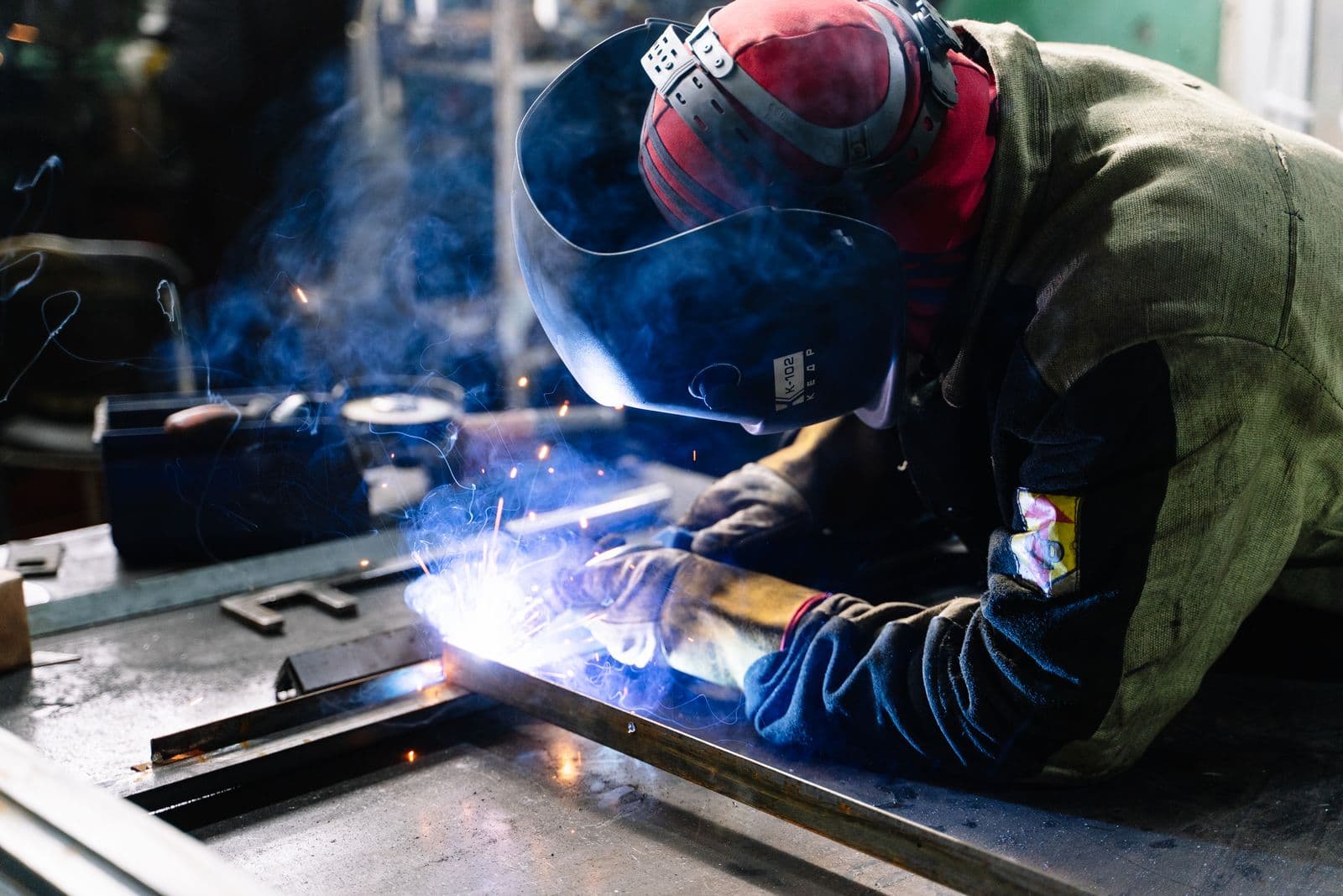 Welding arc with visible fume in a fabrication workshop
